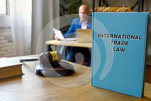 Attorney holds INTERNATIONAL TRADE LAW book. International trade lawÂ includes the rules and customs governingÂ tradeÂ between